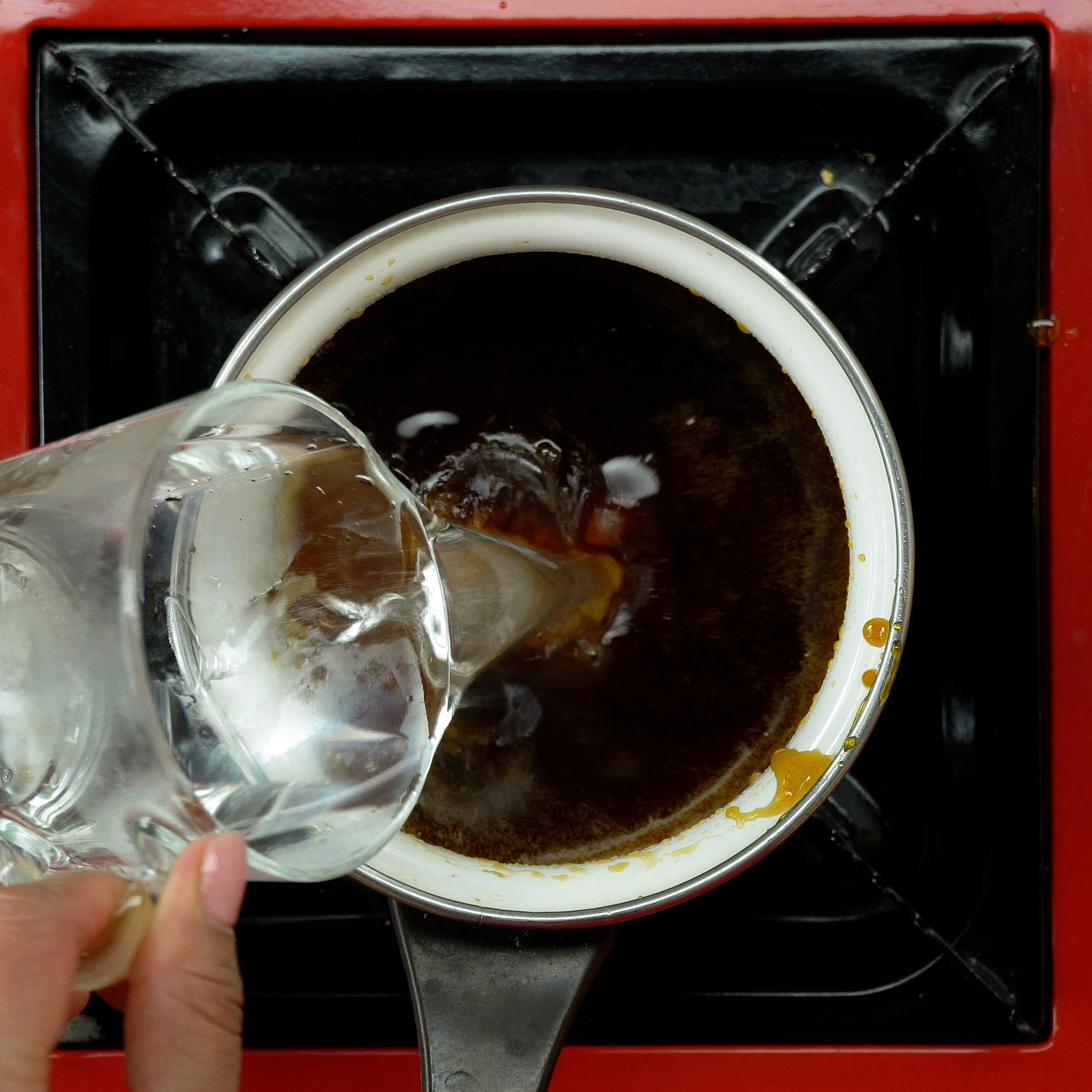 Adicionando água ao caramelo para dissolver.