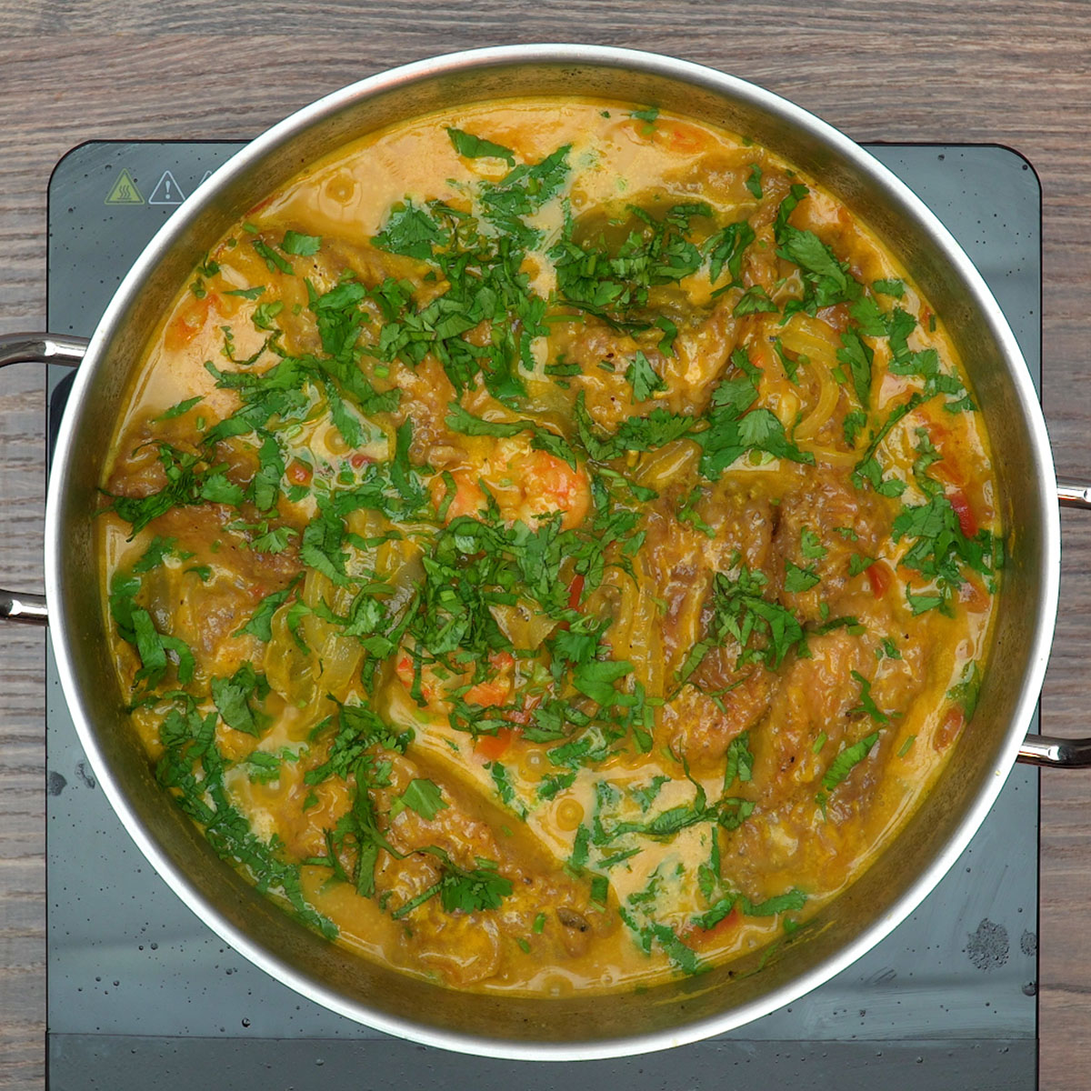 Moqueca de peixe finalizada com coentro fresco picado.