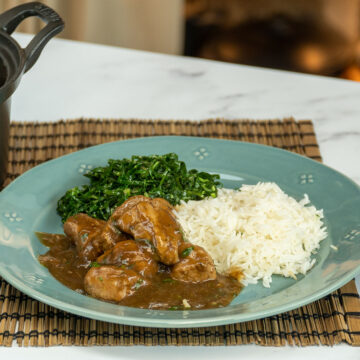 Empratamento dadinho suíno na cerveja preta com arroz e couve de acompanhamento.