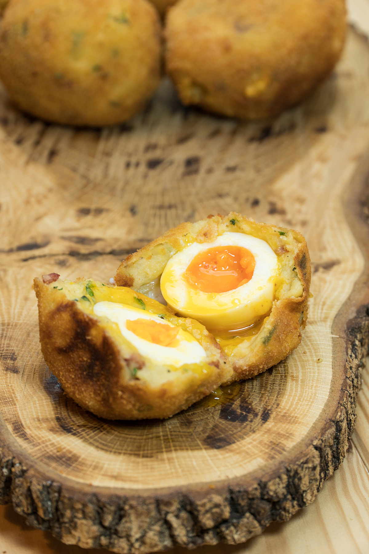Batata surpresa com ovo e bacon sendo servido e cortado ao meio.