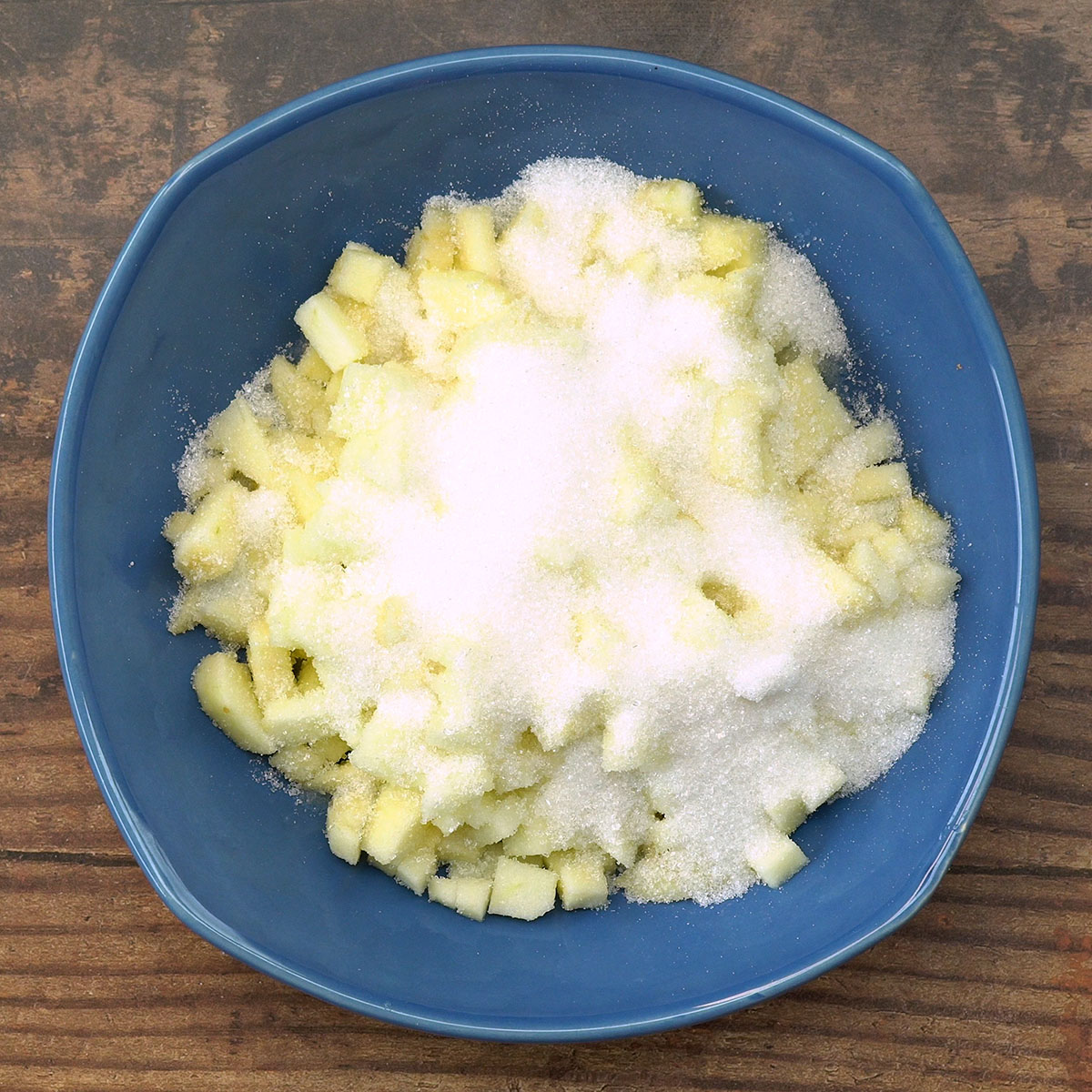 Maçãs misturadas com limão e açúcar para recheio de crumble de maçã.