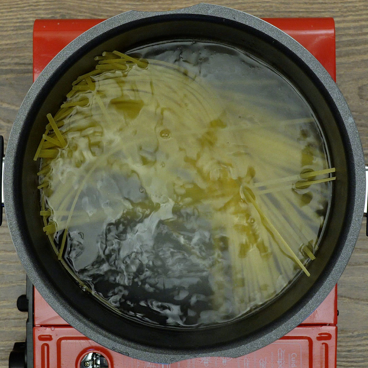 Linguine cozinhando em água fervente até atingir o ponto al dente.